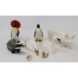 A Beswick Swan, head up, 1684, another, head down, 1685, two Cygnets, 1686 and 1687, a Badger, 3393,