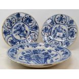 A pair of Dutch Delft plates, decorated foliage, 23.5 cm diameter, and another similar, 30.5 cm