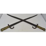 A pair of bayonets, with brass handles (2)