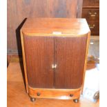 A Regency inlaid mahogany table top cabinet, having a pair of tambour doors above a drawer, on