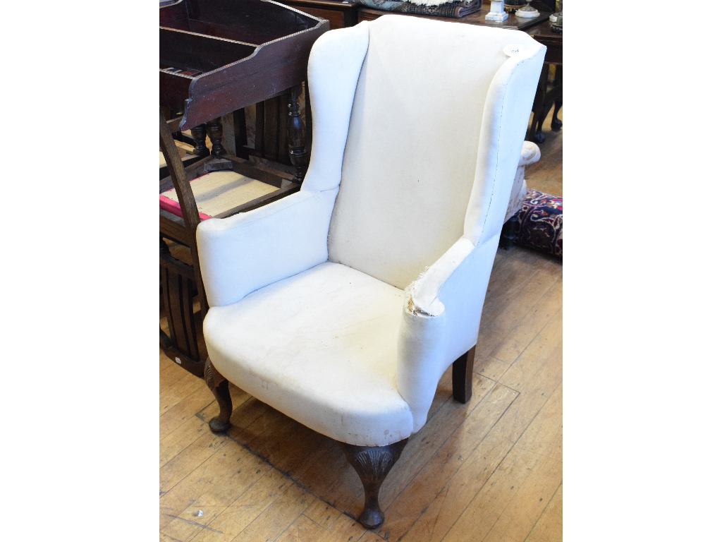An 18th century style wingback armchair, on shell capped cabriole legs
