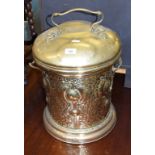 An Art Nouveau brass bin and cover, with embossed and hammered decoration, 51 cm high