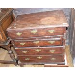 A mahogany bachelor type chest, having a hinged lid, four long drawers and with two slides, in