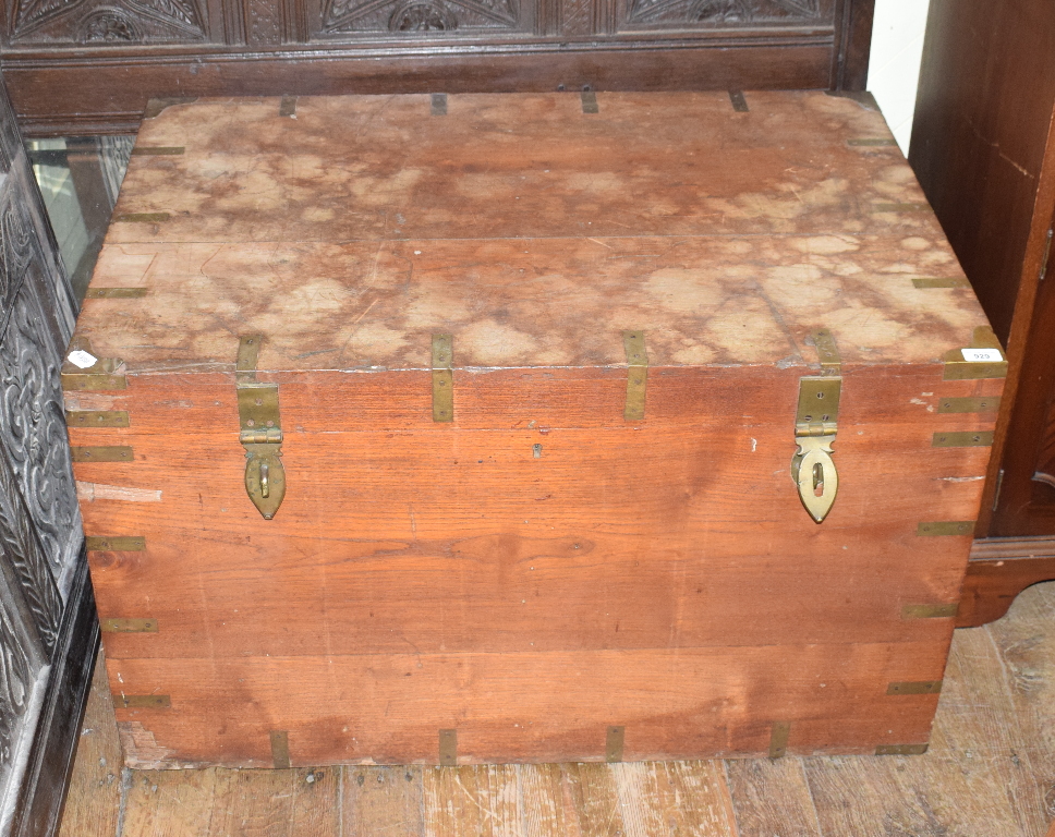 A teak chest, bound in brass, with brass carrying handles to the sides, 98 cm wide Report by RB