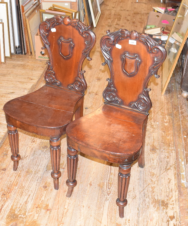 A pair of early Victorian mahogany hall chairs, on tapering reeded legs (2)