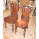A pair of early Victorian mahogany hall chairs, on tapering reeded legs (2)