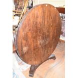 A Regency rosewood tilt top breakfast table, on a triform platform base, 137 cm diameter