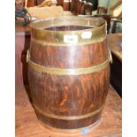 An oval oak bucket, bound in brass, 38 cm high