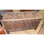 An oak coffer, with carved decoration, on stile legs, 143 cm wide