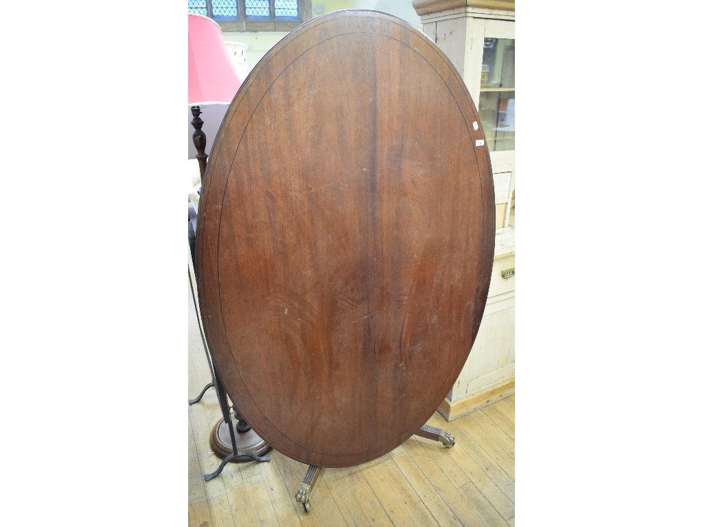 A mahogany oval dining table, on splayed legs, 177 cm wide