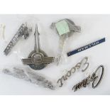 Assorted bonnet insignia and other badges for various models including Ford, Mustang, Ford