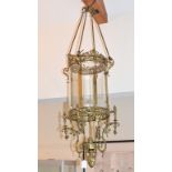 A large brass hall lantern, the shade of circular form with clear bevelled glass panels, on rope