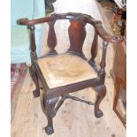 A George III style mahogany corner armchair, on cabriole legs with claw and ball feet Report by GH