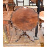 A mahogany tripod table, with a piecrust top, a fluted and reeded vase turned column and leaf carved