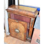 A Victorian inlaid walnut pier cabinet, the arched panel door inset a porcelain plaque decorated