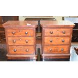 A pair of mahogany table top chests, with three graduated long drawers, on plinth bases, 29 cm