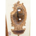 EXTRA LOT: A pair of late Victorian gilt gesso wall mirrors, of shaped form, with shells below, 65 x