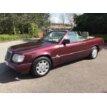 A 1996 Mercedes-Benz E220 Sportline convertible, registration number 823 FDM, Red. Introduced to the