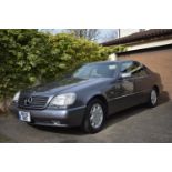 A 1995 Mercedes-Benz S500 W140 coupé , registration number M830 BNO, metallic grey. The W140 S class