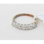 An 18ct gold and seven stone diamond half hoop ring, approx. ring size L, an 18ct gold wedding band,