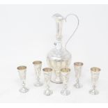 A Russian silver coloured metal seven piece liqueur set, with engraved decoration, the ewer