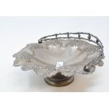 A late Victorian silver swing handled pedestal basket, embossed flowers and with pierced decoration,