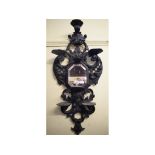 A pair of late 19th century wall mirrors, in carved wood ebonised frames, decorated shells and