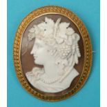 A late 19th century oval shell cameo brooch, carved a bust portrait of a lady with grapes and