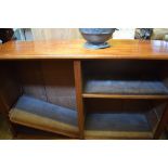 A walnut open bookcase with adjustable shelves, 149 cm wide, a bow front chest of drawers and a