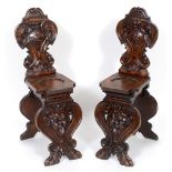 A pair of 19th century Italian carved walnut hall chairs See illustration