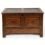 An 18th century inlaid and carved oak mule chest, on stile legs, 119 cm wide See illustration Report