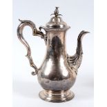 A late 18th century silver coffee pot, of baluster form, with a pineapple finial, and acanthus