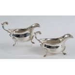 A pair of late George III silver sauce boats, engraved an armorial, with acanthus leaf capped double