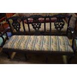 An 18th century style mahogany three chair back settee, with pierced bars shaped splats and cabriole