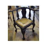 A George III style mahogany corner armchair, on cabriole legs with claw and ball feet