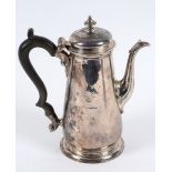 An 18th century silver coffee pot, crested, of baluster form, marks indistinct, approx. 18.6 ozt (