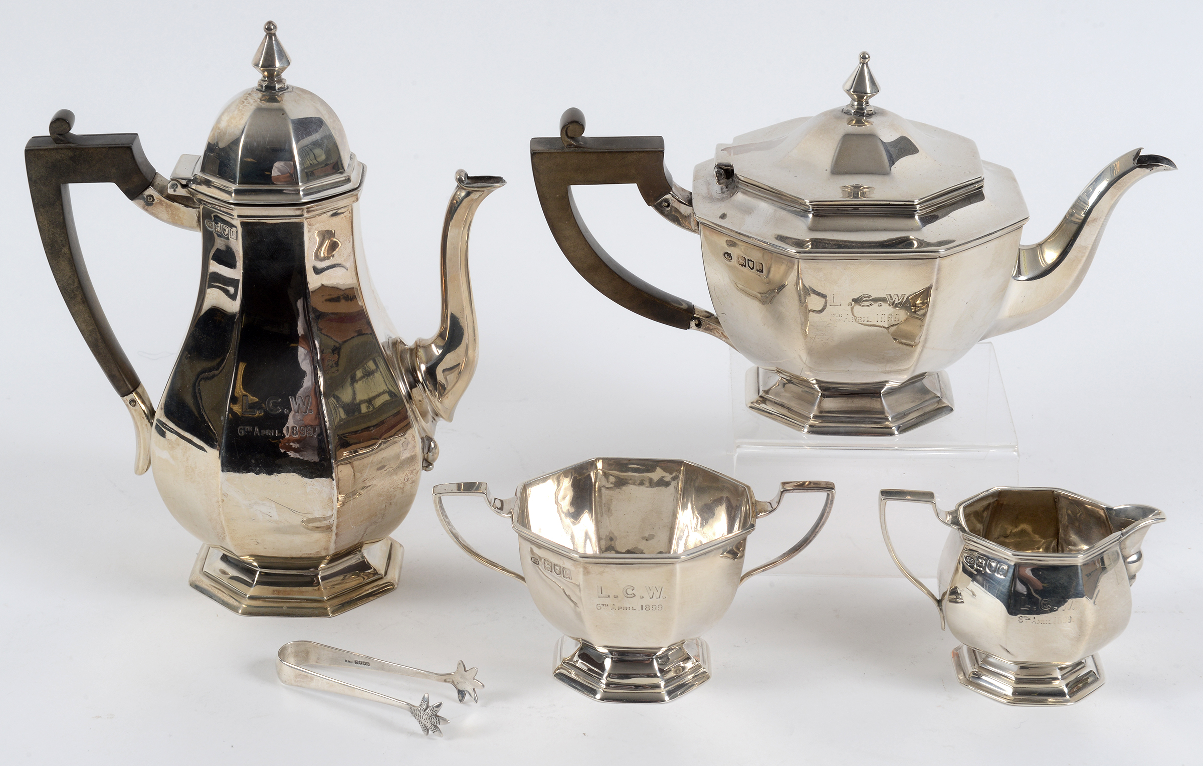 An octagonal silver four piece tea set, initialled and dated, London 1898, and a pair of sugar