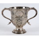 A mid-18th century silver two handled trophy cup, with later embossed decoration, Thomas Wynne (of