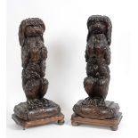 A pair of late 19th century Black Forest carved wood door porters, in the form of standing dogs,