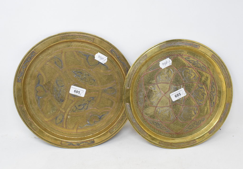 An Eastern inlaid copper tray, decorated calligraphy and stylised foliage, 30 cm diameter, and