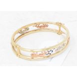 A 9ct three colour gold bangle, decorated Panthers Report by GH Gross weight approx. 13.2 g