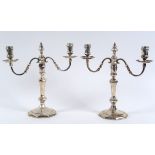 A pair of silver candelabra, in the 18th century taste, on octagonal bases, London 1929, approx.