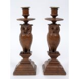 A pair of late 19th century/early 20th century carved wood candlesticks, in the form of owls, 31