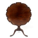 A mahogany tripod table, with a piecrust top, a fluted and reeded vase turned column and leaf carved