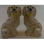 A pair of Staffordshire pottery spaniels, with baskets, 23 cm high (2) Report by GH Paint loss