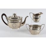 An early 19th century style silver three piece tea set, with engraved decoration, London 1912,