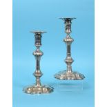 A pair of 18th century Irish cast silver candlesticks, crested, with detachable sconces, on