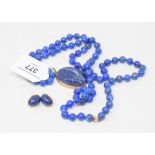 A lapis lazuli bead necklace, a matching pendant and a pair of earrings