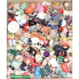 A collection of assorted novelty tape measures, mostly plastic, in various forms including