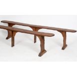 A pair of elm forms or benches, on triple supports, 237 cm wide See illustration